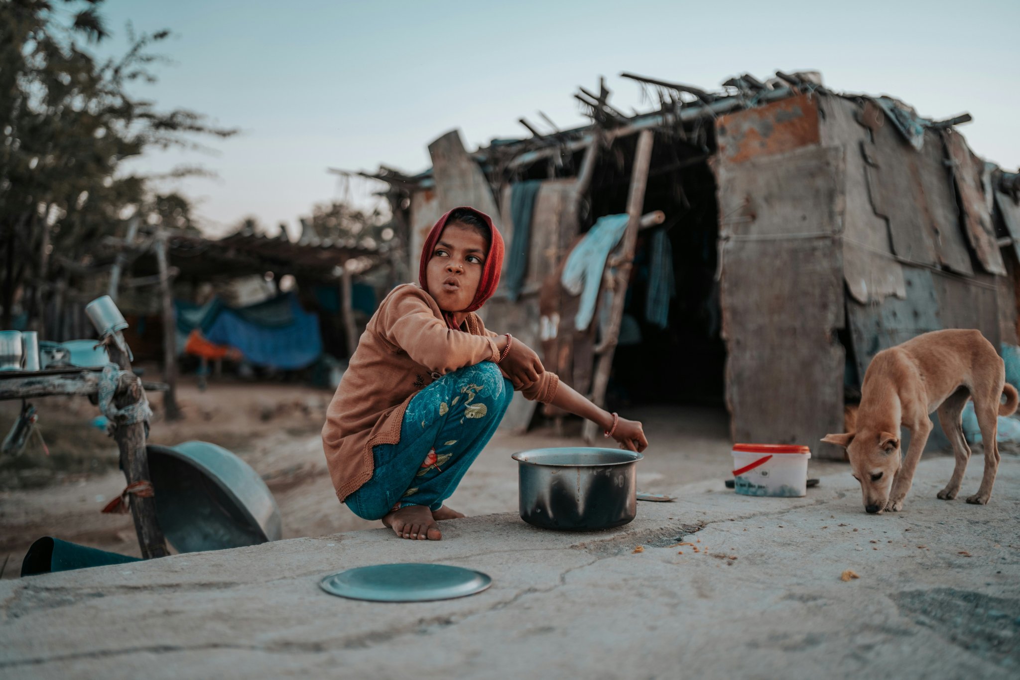 A woman practicing yoga outdoors during sunset