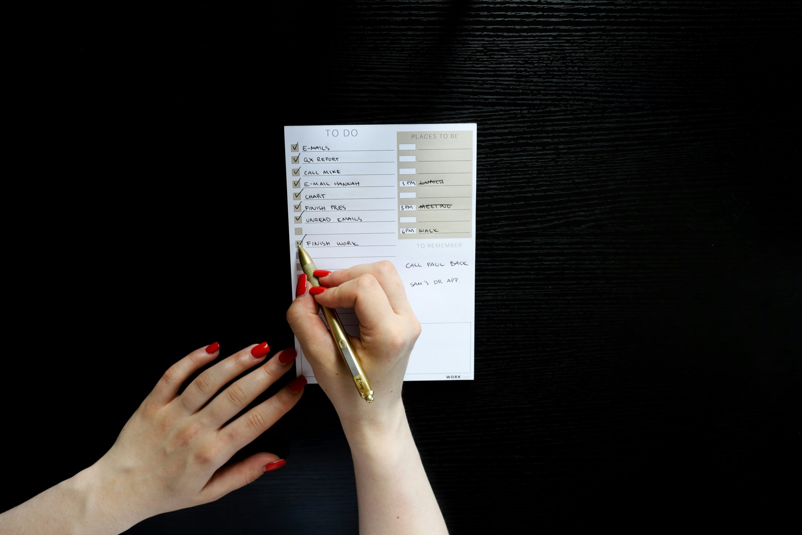 Person writing in a journal next to a cup of coffee, emphasizing mindful habit tracking.