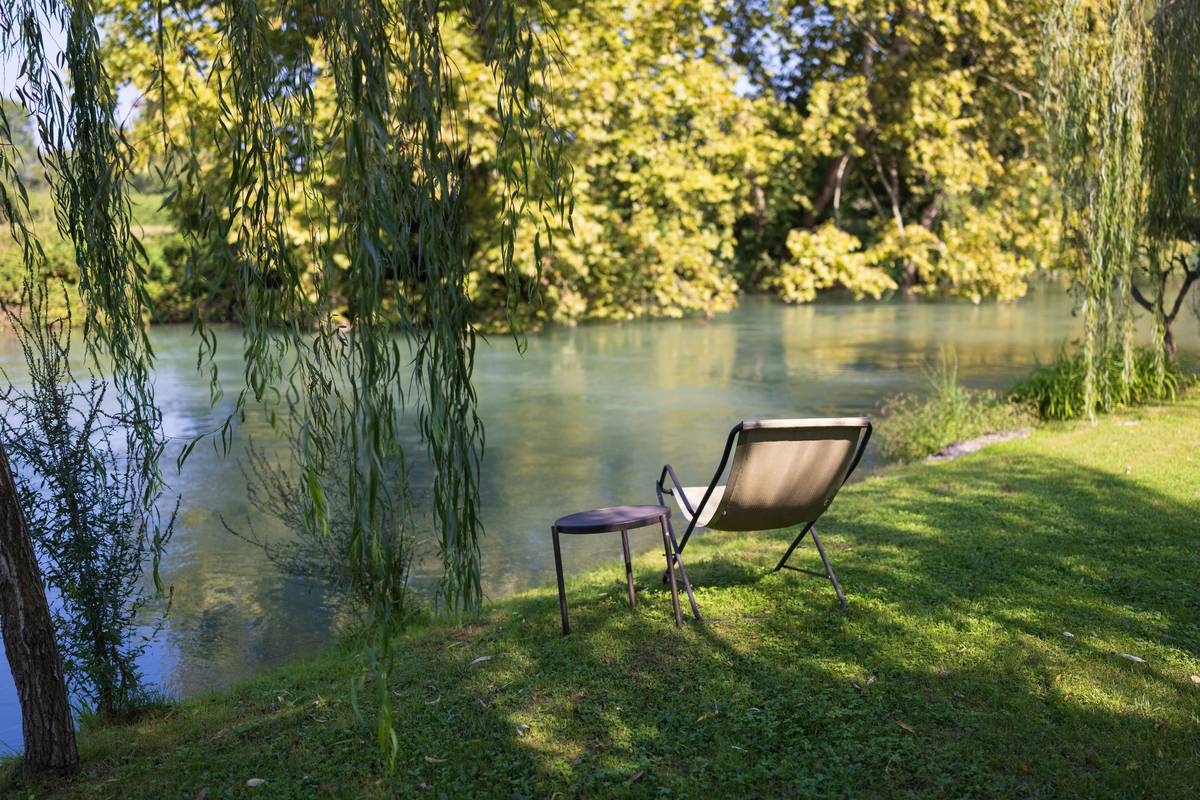 A person sitting cross-legged in a park, practicing mindful meditation