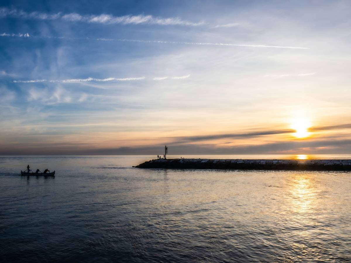 A person sitting cross-legged in meditation pose with soft lighting