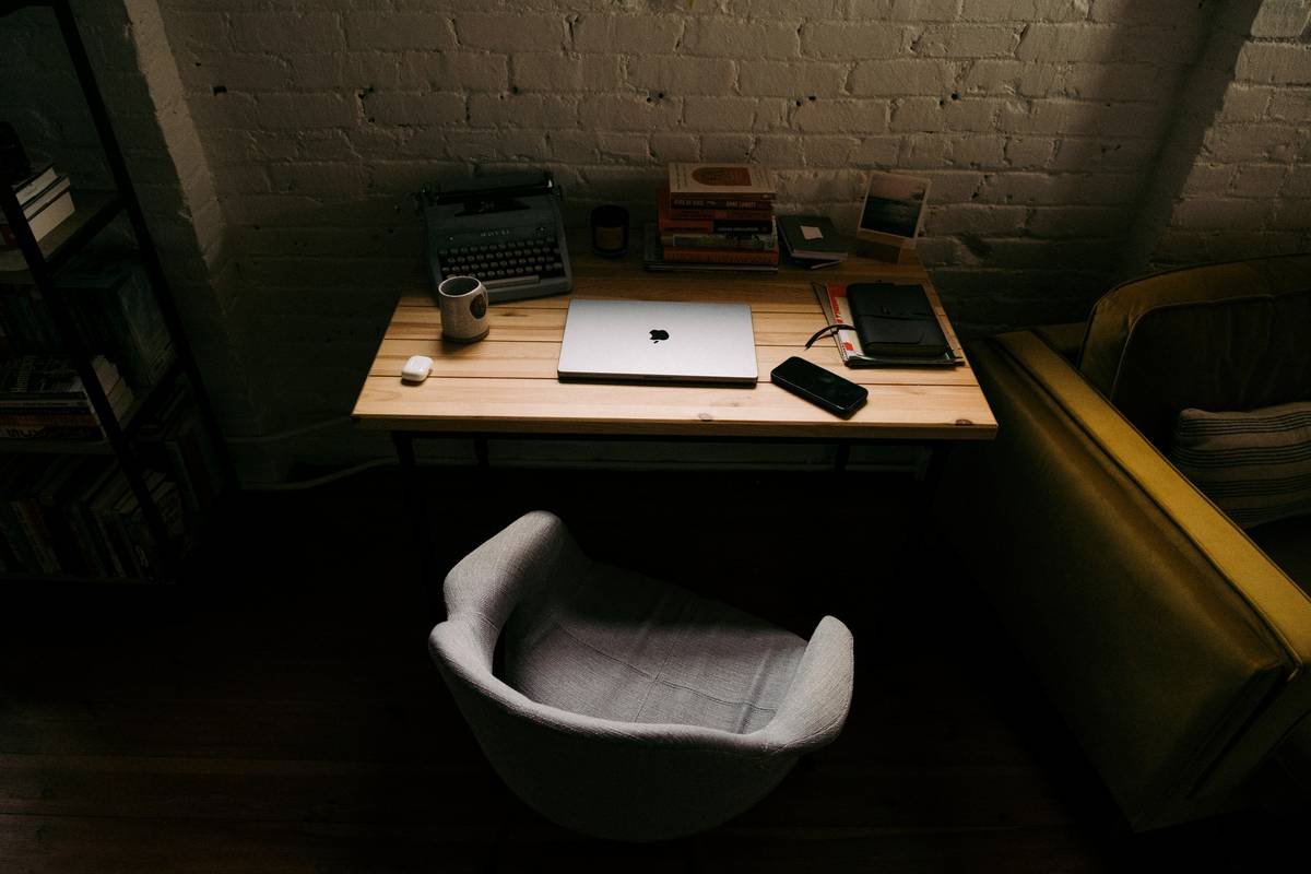 a laptop computer sitting on top of a wooden desk